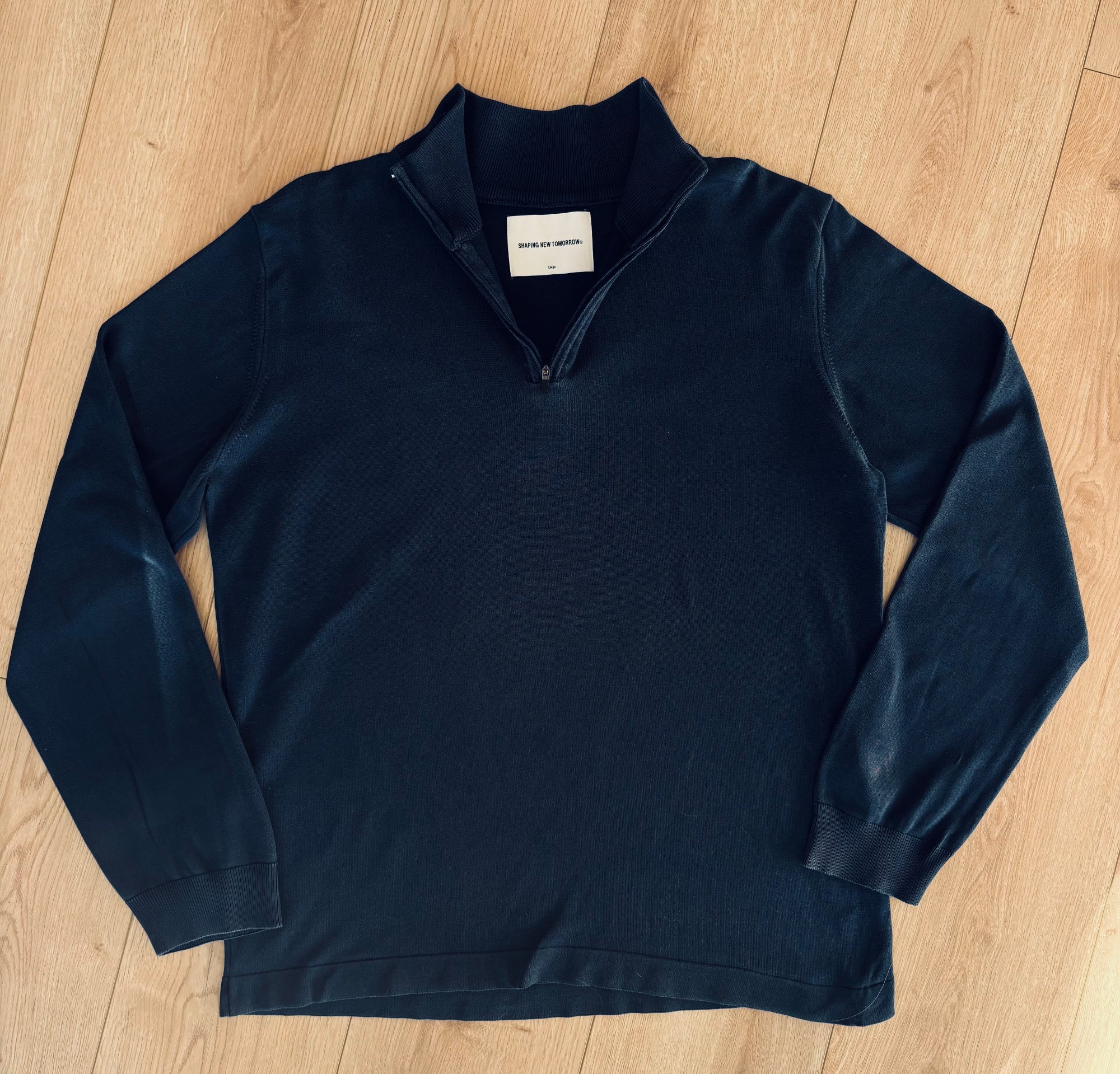Mørk grå sweatshirt fra Fabricobe med kvart-zip-lynlås og afslappet pasform, perfekt til hverdagsbrug.